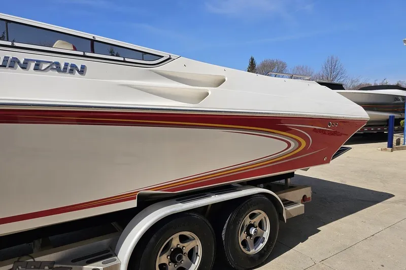 Slide: The Image of 2007 Fountain 35 Lightning boat on trailer, featuring sleek red and white design. - 23