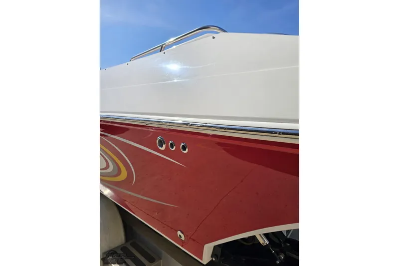 Slide: The Image of 2007 Fountain 35 Lightning boat with red and white exterior under clear blue sky. - 27