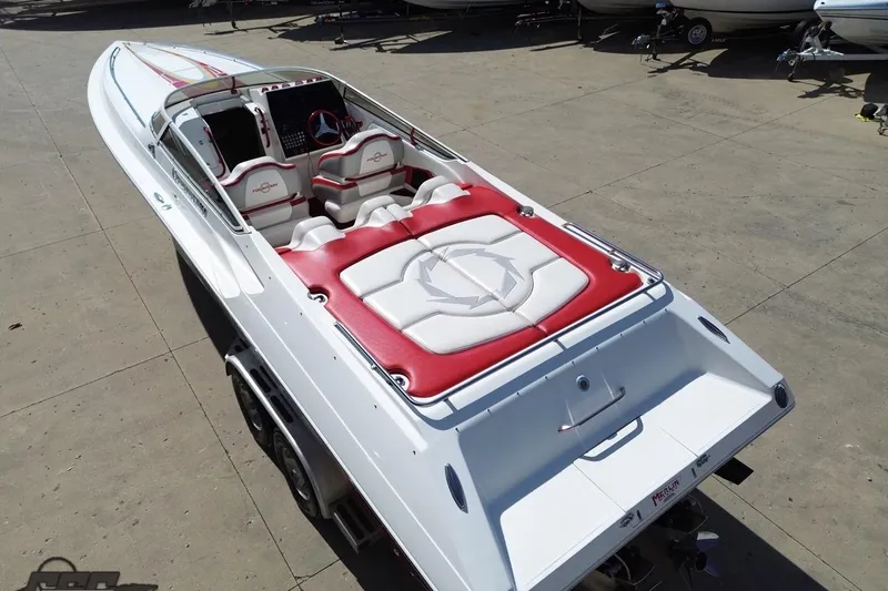 Slide: The Image of 2007 Fountain 35 Lightning speedboat with red and white seating, parked on concrete. - 33