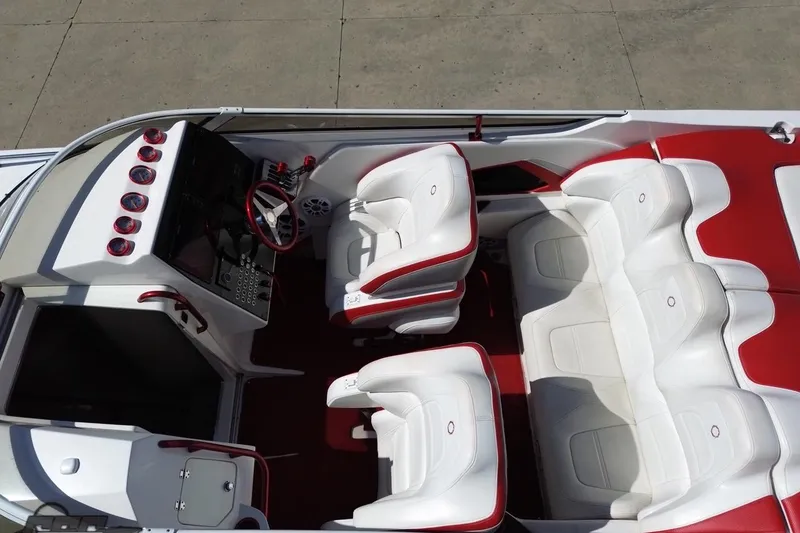 Slide: The Image of 2007 Fountain 35 Lightning boat interior with white and red seating, dashboard, and steering wheel. - 34