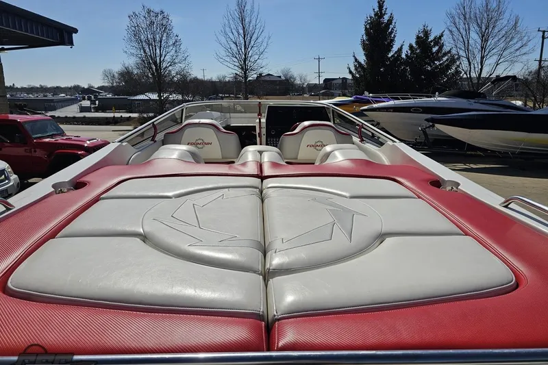 Slide: The Image of 2007 Fountain 35 Lightning boat with red and white seating, parked outdoors. - 39