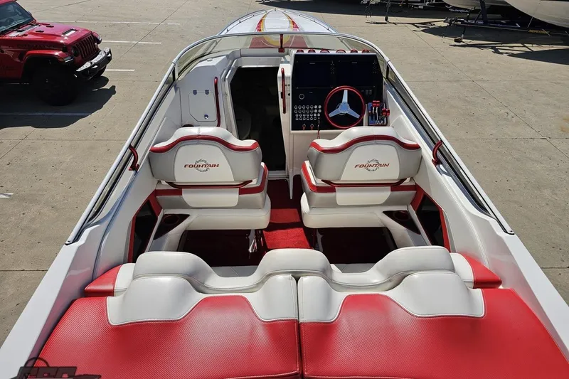 Slide: The Image of 2007 Fountain 35 Lightning boat interior with red and white seating, steering wheel, and dashboard. - 44