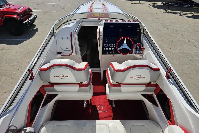 Slide: The Image of 2007 Fountain 35 Lightning boat interior with red and white seating and dashboard. - 45
