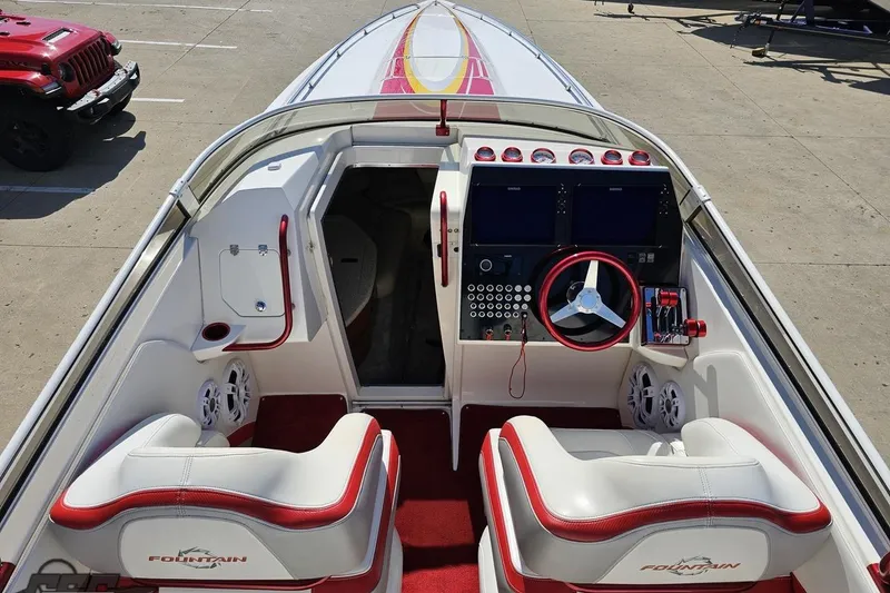 Slide: The Image of 2007 Fountain 35 Lightning boat interior with red and white seating, dashboard, and steering wheel. - 47