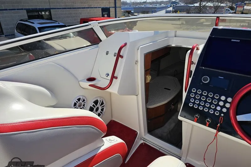 Slide: The Image of 2007 Fountain 35 Lightning boat interior with red accents and modern control panel. - 56