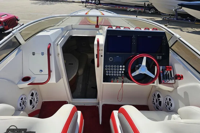 Slide: The Image of 2007 Fountain 35 Lightning boat interior with red accents and modern dashboard controls. - 61