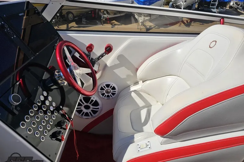 Slide: The Image of 2007 Fountain 35 Lightning boat cockpit with red and white interior, steering wheel, and controls. - 62