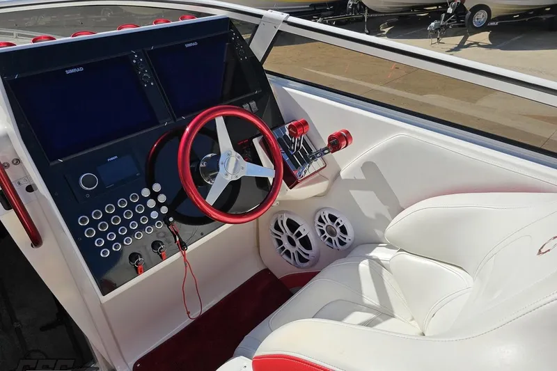 Slide: The Image of 2007 Fountain 35 Lightning boat cockpit with dual screens, red accents, and white seating. - 63