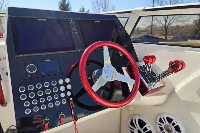 Slide: The Image of 2007 Fountain 35 Lightning boat dashboard with red steering wheel and control panel. - 65