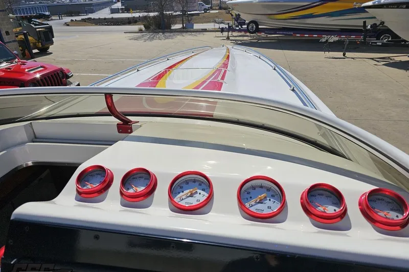 Slide: The Image of 2007 Fountain 35 Lightning boat dashboard with red gauges and sleek design. - 69