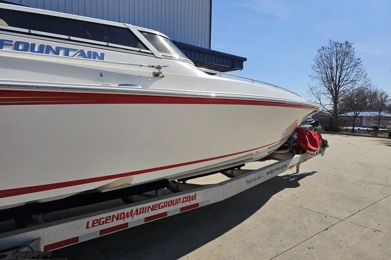 Slide: The Image of 2007 Fountain 35 Lightning boat on trailer, white with red accents, outdoor setting. - 7