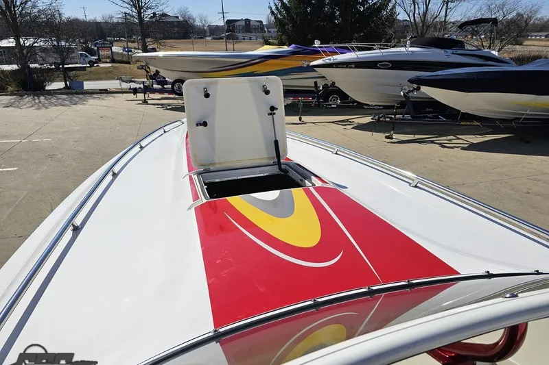 Slide: The Image of 2007 Fountain 35 Lightning boat with vibrant red and yellow design, docked outdoors. - 70