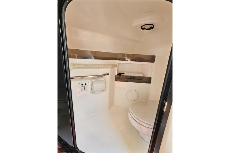 Slide: The Image of 2007 Fountain 35 Lightning boat interior bathroom with toilet and storage shelves. - 77