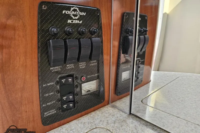 Slide: The Image of Control panel of a 2007 Fountain 35 Lightning boat with switches and indicators. - 82
