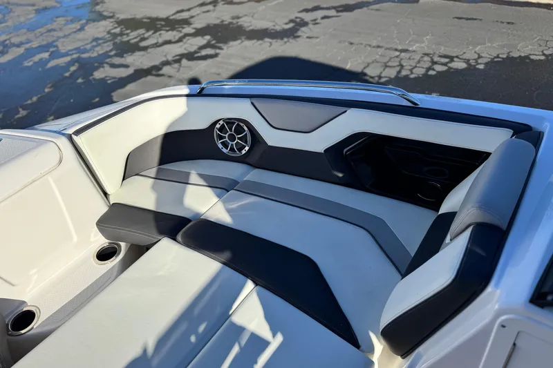 Slide: The Image of 2022 Yamaha Boats 212SE interior with sleek seating and speaker detail. - 16