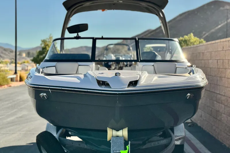 Slide: The Image of 2022 Yamaha Boats 212SE in a scenic outdoor setting, showcasing sleek design. - 2