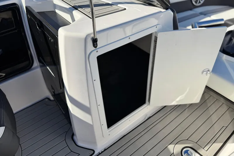 Slide: The Image of Open storage compartment on 2022 Yamaha Boats 212SE, featuring sleek interior design. - 24
