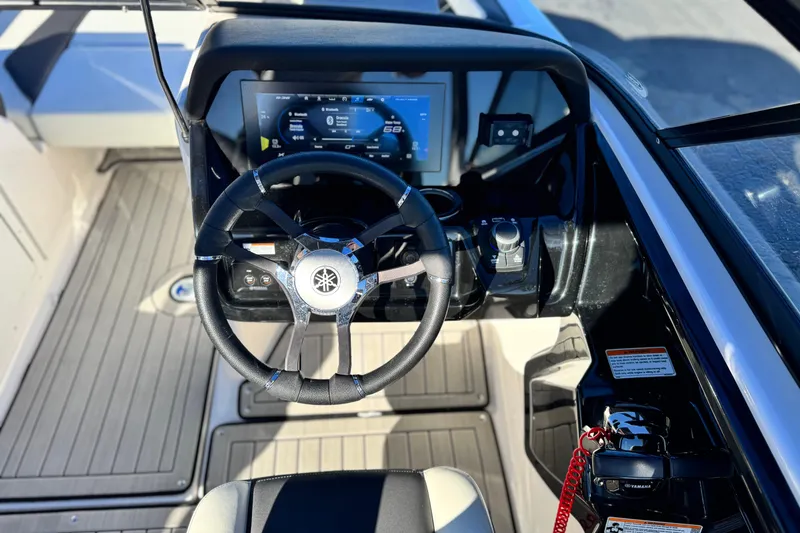 Slide: The Image of 2022 Yamaha Boats 212SE dashboard with steering wheel and digital display. - 26