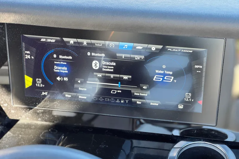 Slide: The Image of 2022 Yamaha Boats 212SE dashboard display showing music and water temperature. - 30