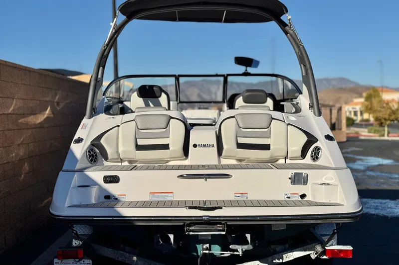 Slide: The Image of 2022 Yamaha Boats 212SE, rear view, showcasing sleek design and comfortable seating. - 4