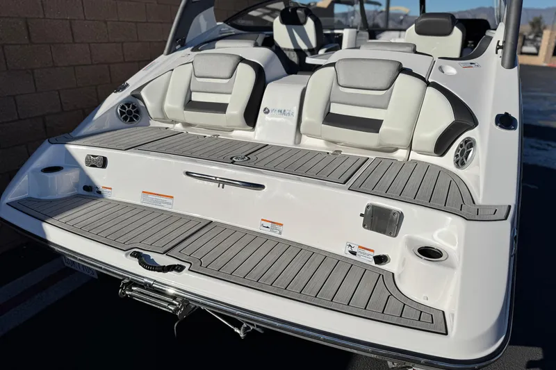 Slide: The Image of 2022 Yamaha Boats 212SE, rear view, showcasing seating and deck design. - 6
