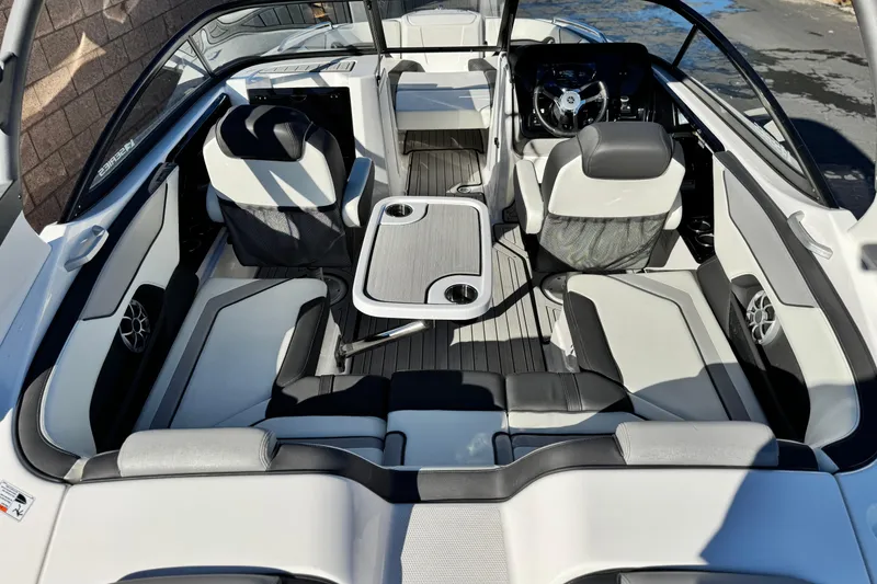Slide: The Image of 2022 Yamaha Boats 212SE interior with seating, table, and steering wheel, showcasing modern design. - 9