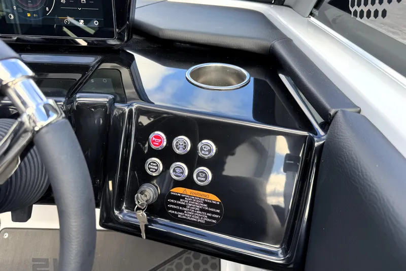 Slide: The Image of Control panel of 2026 Scarab 210 LX boat with steering wheel and buttons. - 13