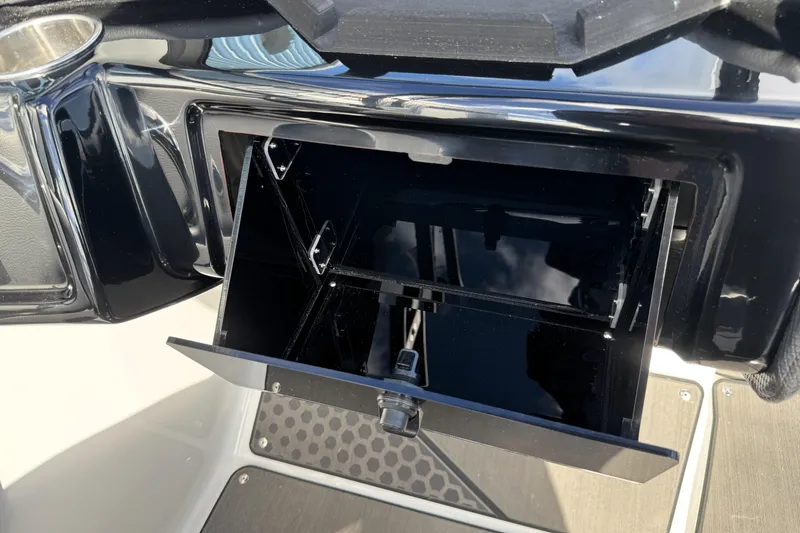 Slide: The Image of Open storage compartment in 2026 Scarab 210 LX boat interior. - 16