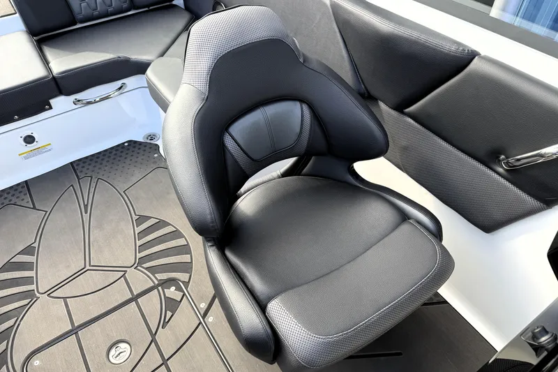 Slide: The Image of 2026 Scarab 210 LX boat interior with sleek black seating and stylish flooring design. - 17
