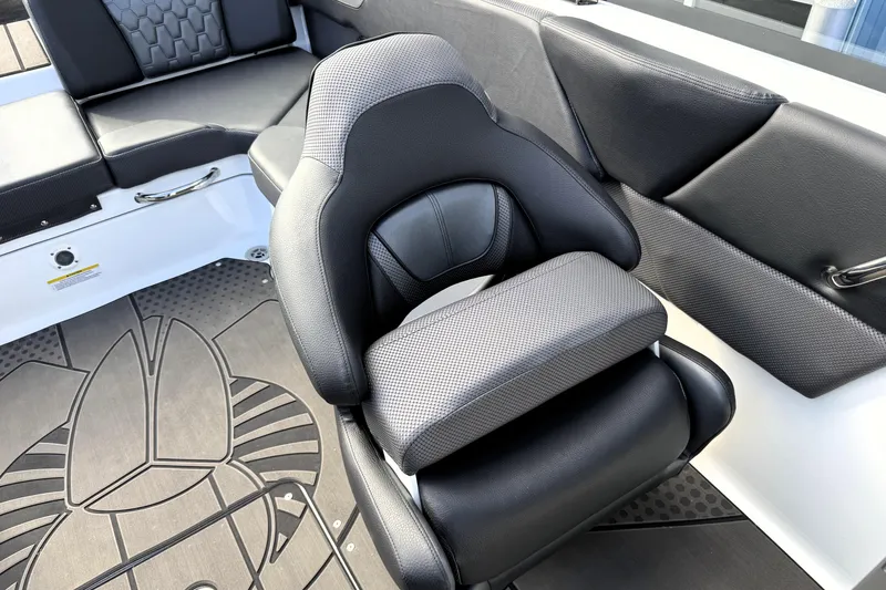 Slide: The Image of 2026 Scarab 210 LX boat interior with black seating and stylish flooring design. - 18