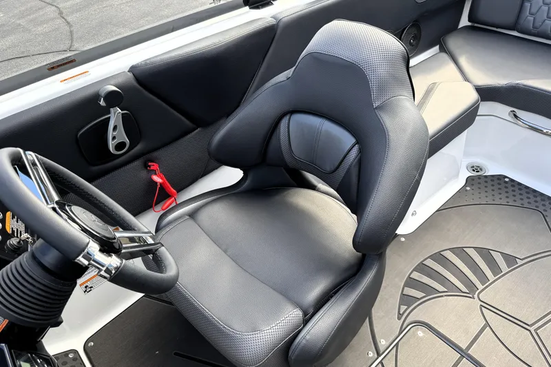 Slide: The Image of 2026 Scarab 210 LX boat interior with sleek black seating and modern steering wheel. - 19