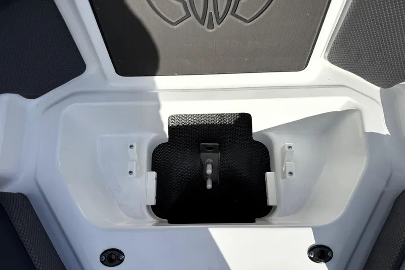 Slide: The Image of 2026 Scarab 210 LX boat storage compartment with black and white interior design. - 24