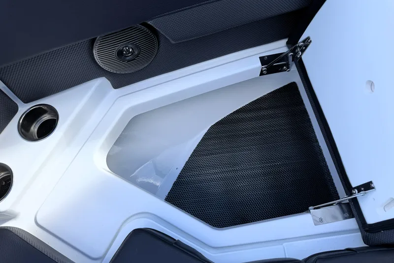 Slide: The Image of Open storage compartment in 2026 Scarab 210 LX boat interior. - 25