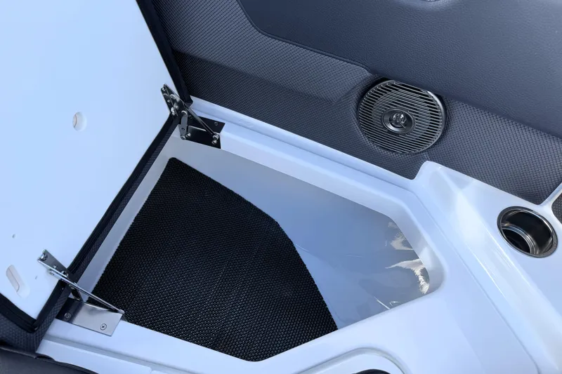 Slide: The Image of 2026 Scarab 210 LX boat interior storage compartment with speaker and cup holder. - 26