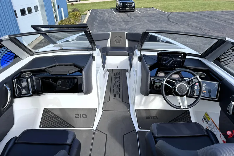 Slide: The Image of 2026 Scarab 210 LX boat interior with modern dashboard and seating. - 28