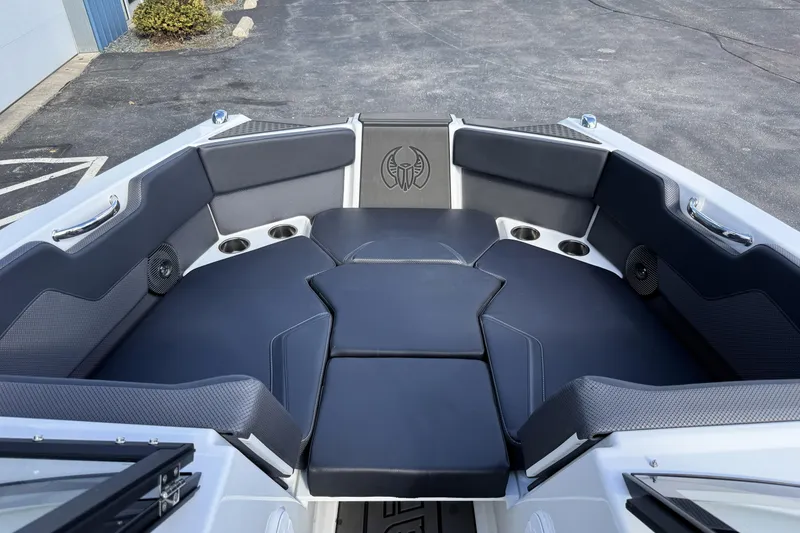 Slide: The Image of 2026 Scarab 210 LX boat interior with sleek black seating and cup holders. - 30