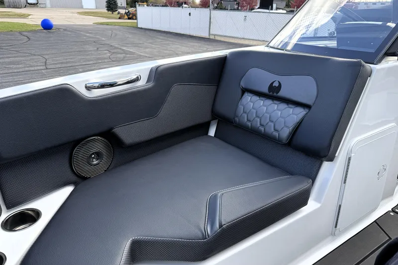 Slide: The Image of 2026 Scarab 210 LX boat interior with sleek black seating and integrated speaker. - 33