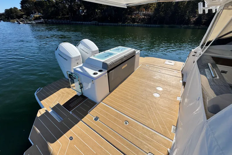 Slide: The Image of 2025 Regal LX43 boat with dual Mercury engines on a sunny lake. - 16