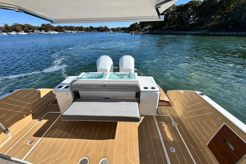 Slide: The Image of 2025 Regal LX43 boat with dual engines, spacious deck, and scenic waterway view. - 18