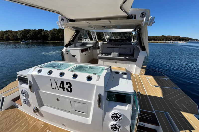 Slide: The Image of Luxurious 2025 Regal LX43 boat with spacious deck and modern amenities on serene water. - 21