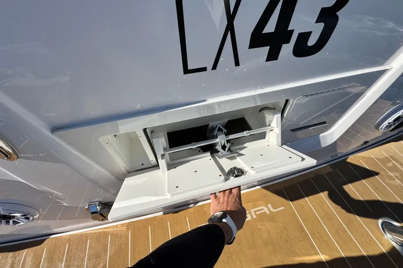 Slide: The Image of 2025 Regal LX43 yacht with open storage compartment on deck. - 22