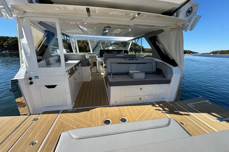 Slide: The Image of Luxurious 2025 Regal LX43 yacht interior with elegant seating and modern amenities on a serene lake. - 23