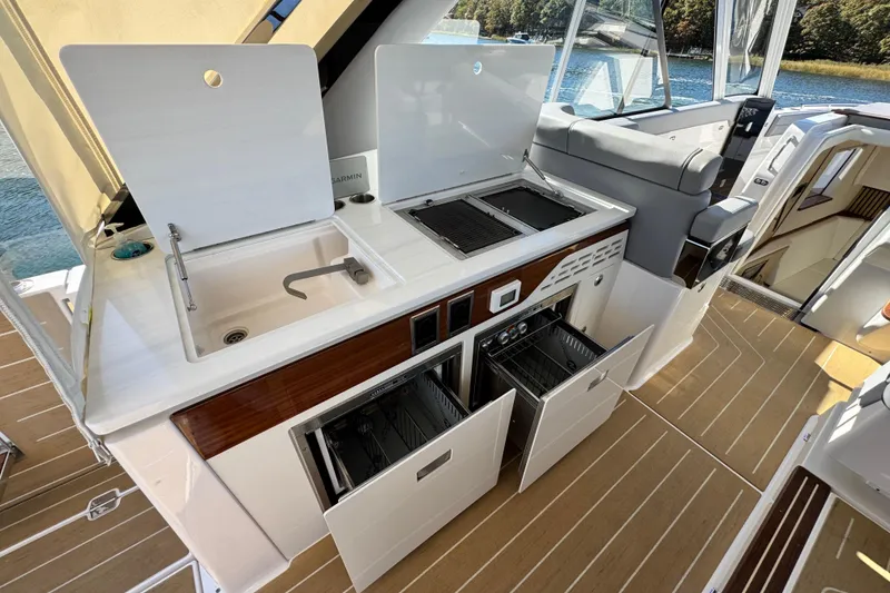 Slide: The Image of Luxurious 2025 Regal LX43 yacht kitchen with sink, grill, and storage drawers. - 32