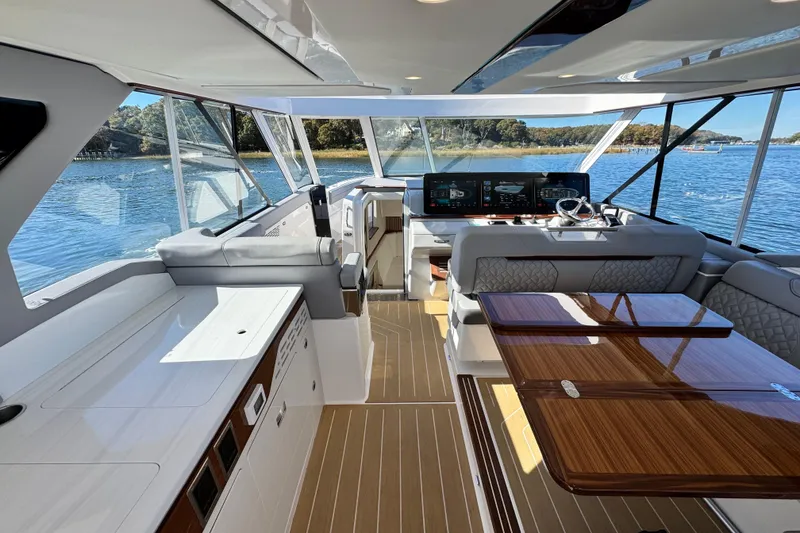 Slide: The Image of Luxurious interior of 2025 Regal LX43 yacht with elegant seating and modern dashboard. - 33