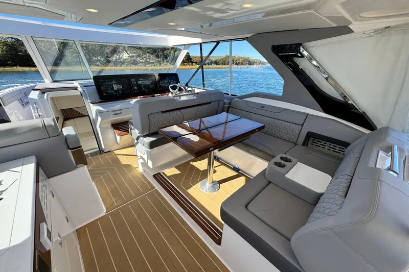 Slide: The Image of Luxurious interior of 2025 Regal LX43 yacht with elegant seating and modern dashboard. - 34