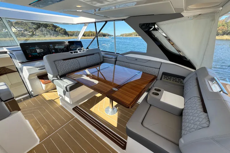 Slide: The Image of Luxurious interior of 2025 Regal LX43 yacht with elegant seating and modern dashboard. - 35