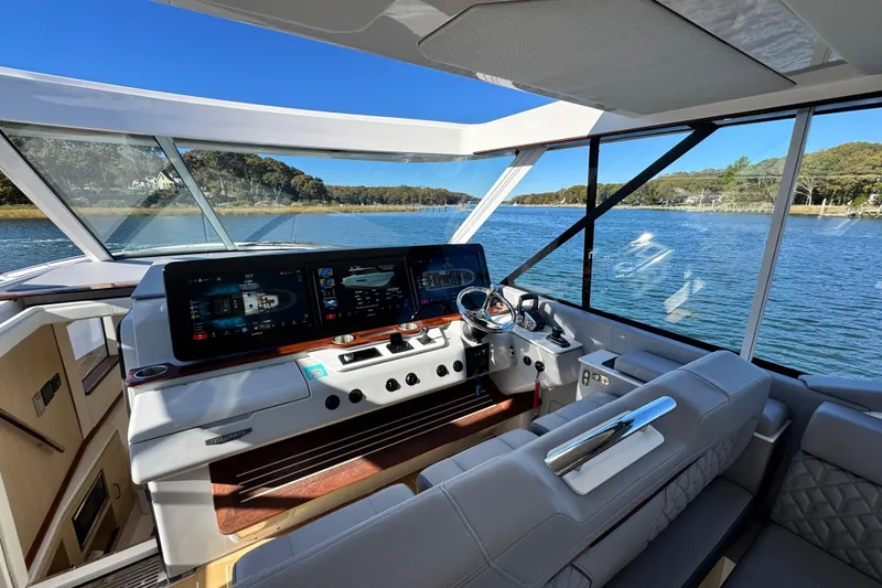 Slide: The Image of Luxurious 2025 Regal LX43 yacht interior with advanced navigation system and scenic water view. - 37