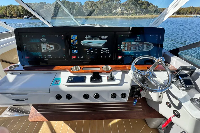 Slide: The Image of Helm of 2025 Regal LX43 boat with advanced navigation screens and controls. - 38