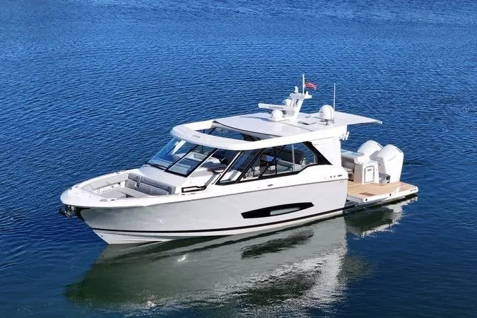 Slide: The Image of 2025 Regal LX43 luxury boat on calm blue water, showcasing sleek design and modern features. - 4