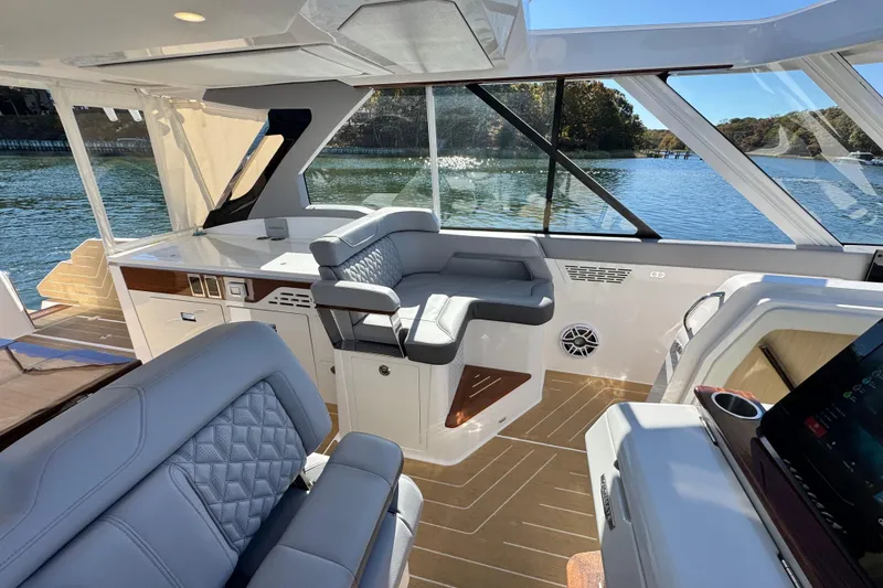 Slide: The Image of Luxurious interior of 2025 Regal LX43 yacht with plush seating and scenic water view. - 43
